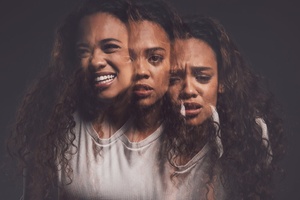 Individual sitting in low light appearing hopeless, representing schizoaffective disorder