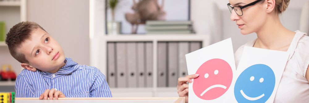 Young child struggling with focus while studying at desk, illustrating ADHD symptoms
