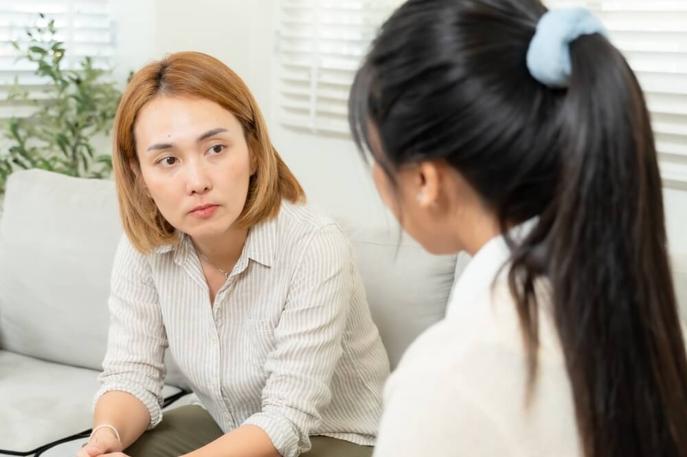 Doctor consulting with child and parent about ADHD treatment options in clinical setting