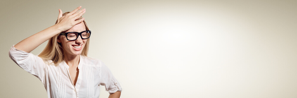 Adult woman holding her head while multitasking, illustrating executive dysfunction and cognitive overload symptoms of ADHD.