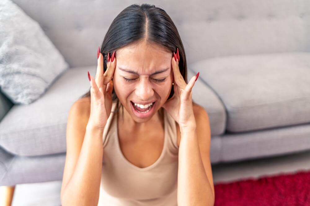 Adult woman appearing stressed, representing time management and executive functioning challenges in adult ADHD.