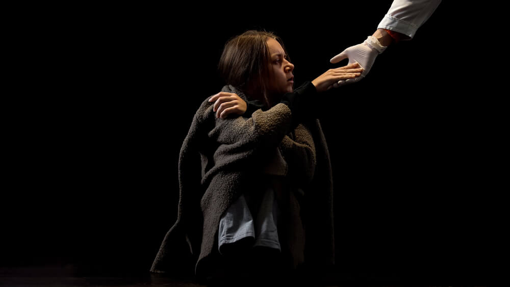 drug addict taking helping hand of doctor to get substance abuse treatment at center in Florida providing substance use disorder treatment and recovery programs.