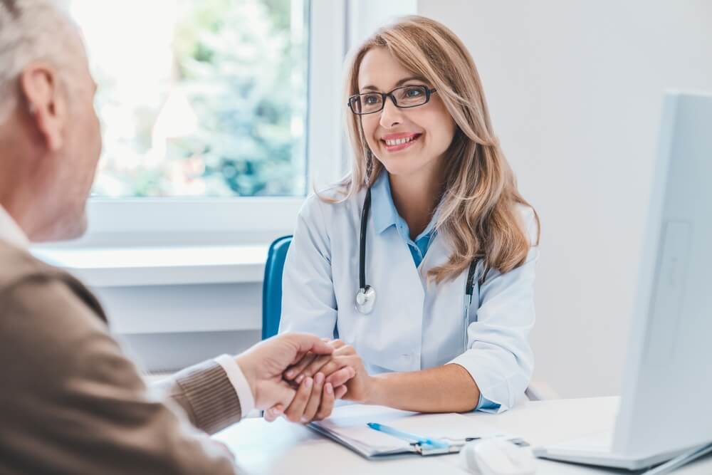 Doctor discussing dementia symptoms and treatment options with an elderly patient