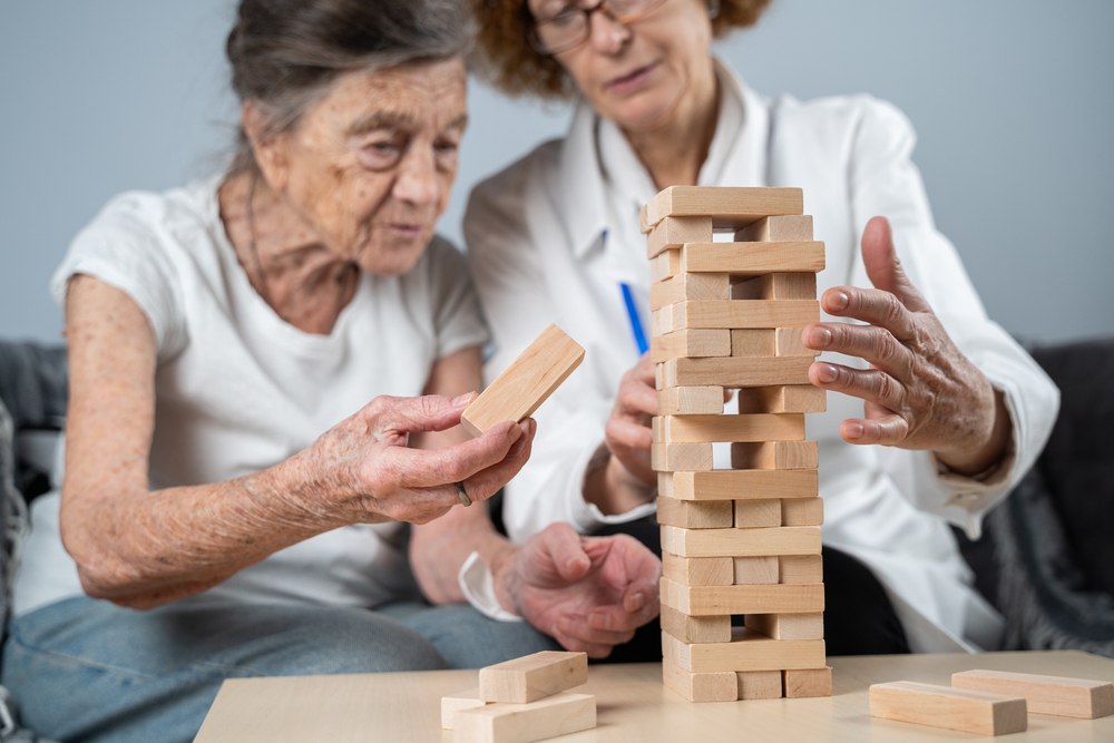 Therapist assisting a patient with cognitive rehabilitation exercises for memory support