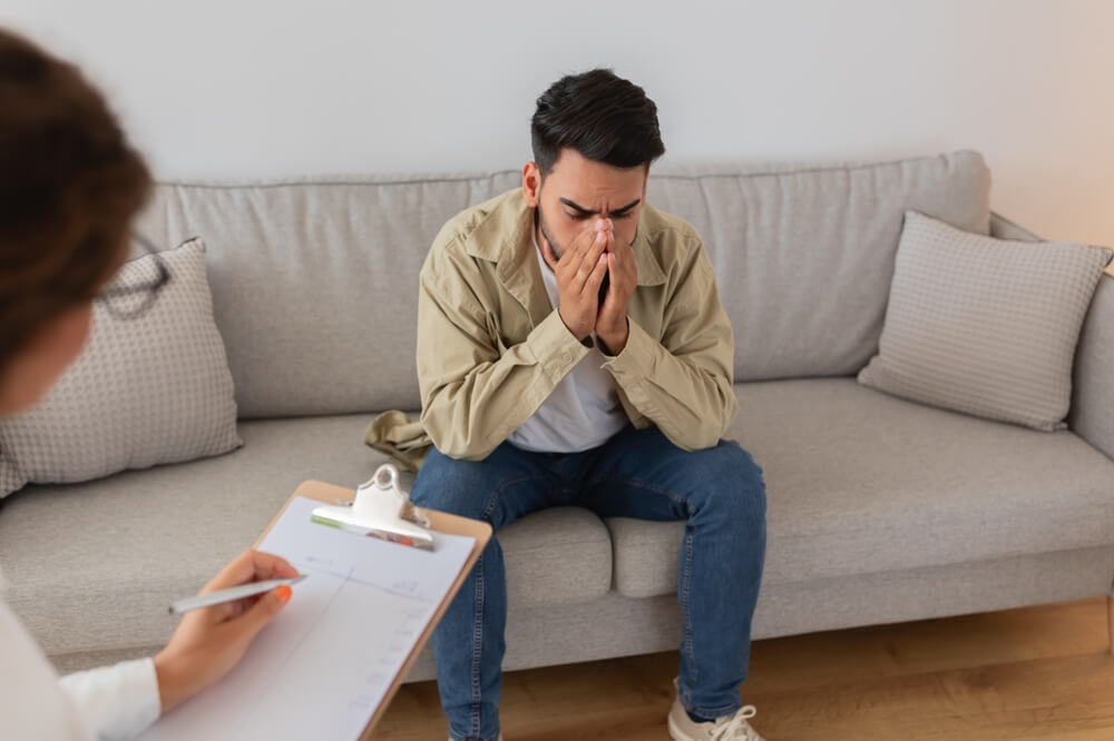 patient discussing traumatic experiences with psychologist during PTSD counseling