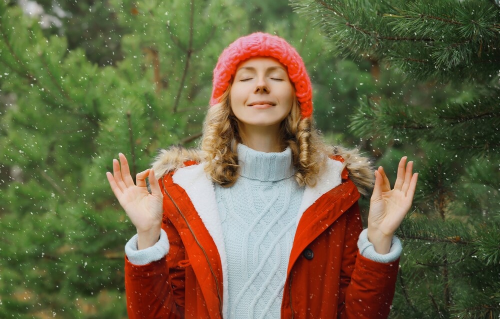 woman practicing meditation and breathing exercises to manage PTSD stress
