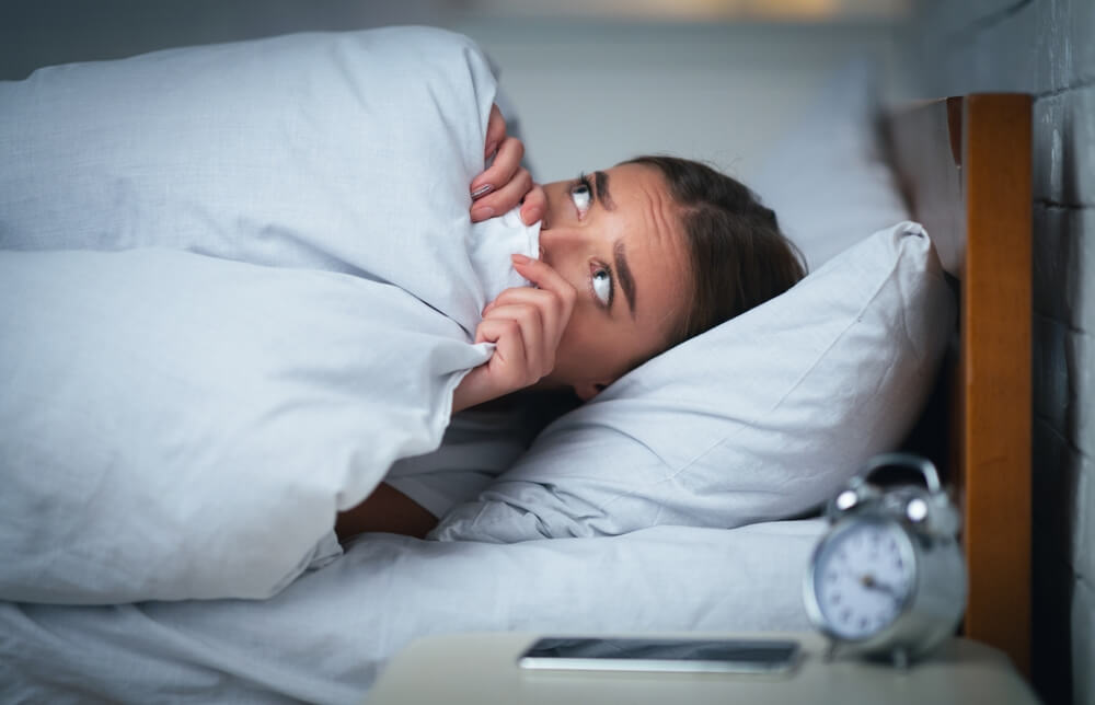 woman looking exhausted in the morning due to chronic sleep deprivation and insomnia