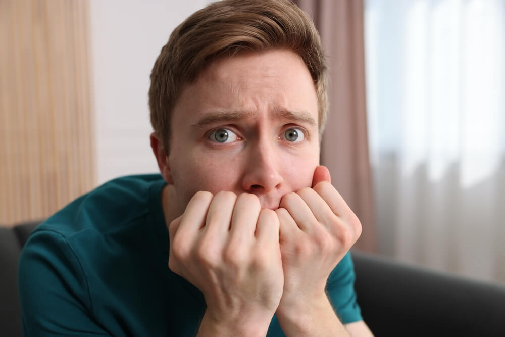 Person appearing frightened, confused and distressed due to delusions and paranoia