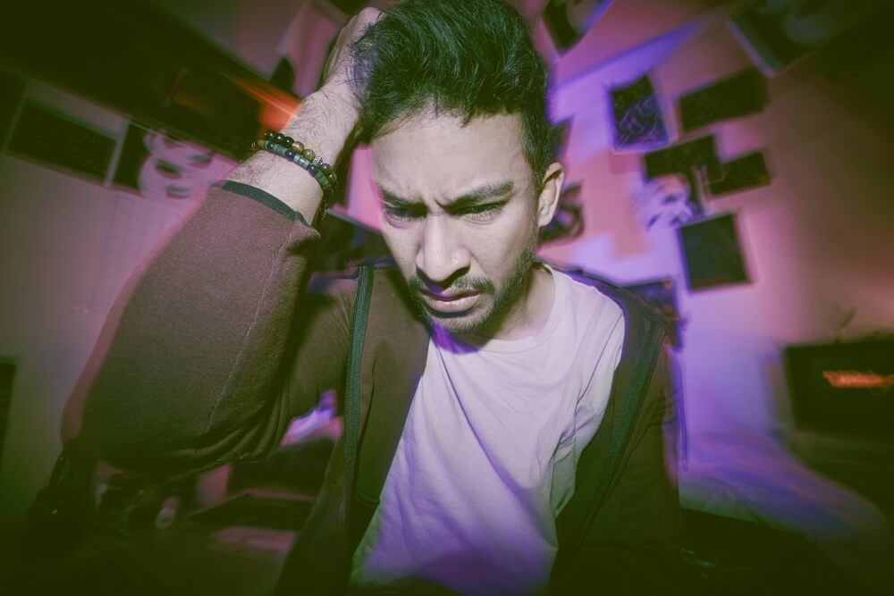 Person experiencing sudden panic attack with rapid heartbeat and difficulty breathing