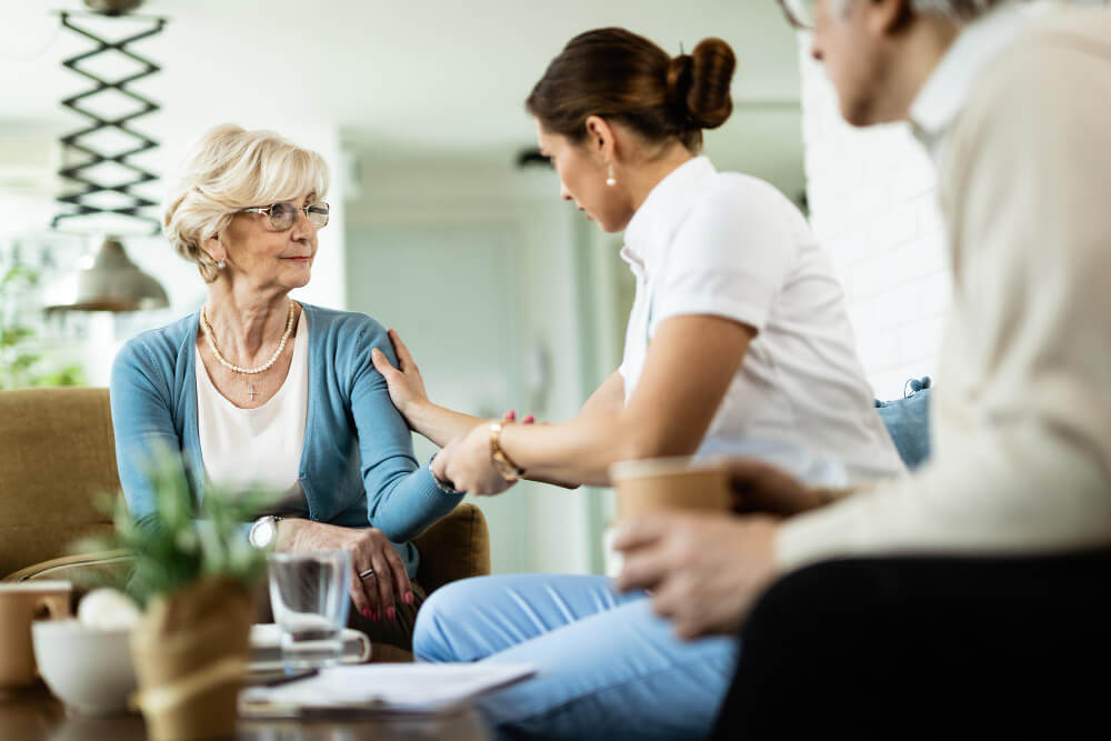 Clinical social worker assisting old lady with mental health support