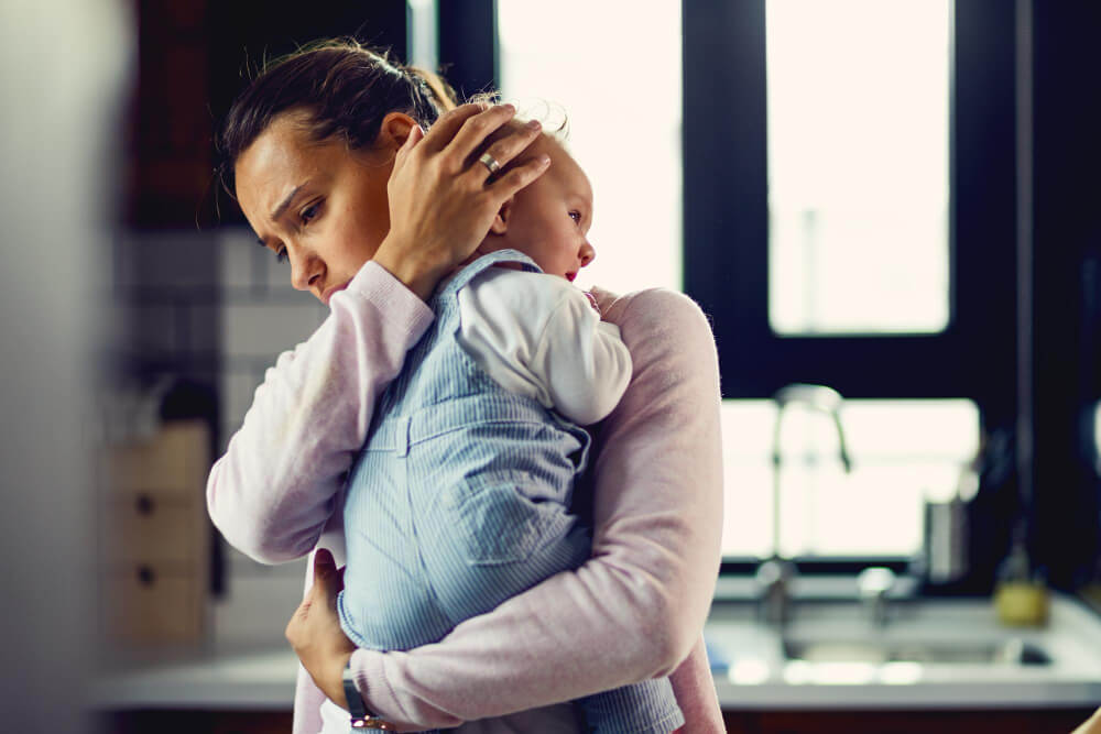 Mother walking outdoors with baby showing healthy lifestyle changes for mental health