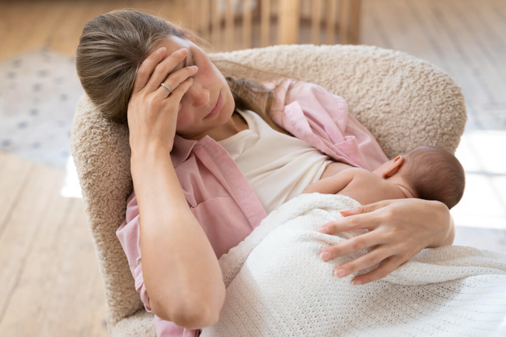New mother feeling sad and disconnected, representing postpartum depression symptoms