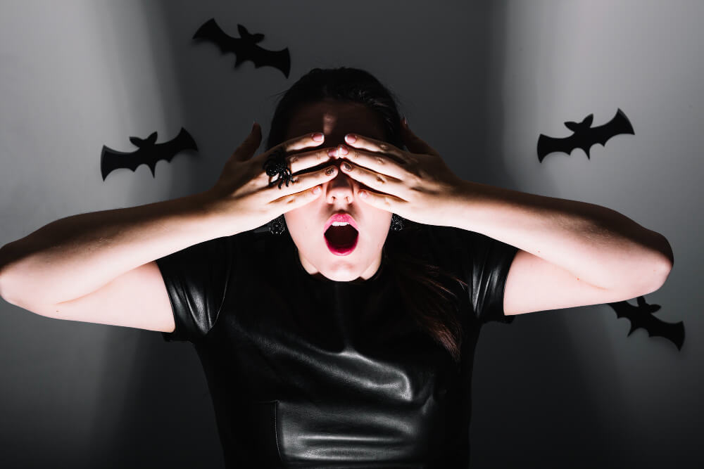 frightened individual reacting to bat in dark environment illustrating chiroptophobia