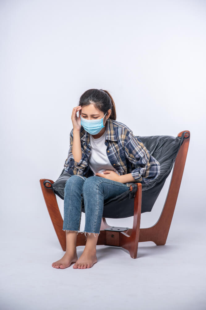 women representing physical symptoms of bulimia nervosa such as stomach ache, sore throat, dental damage, and fatigue