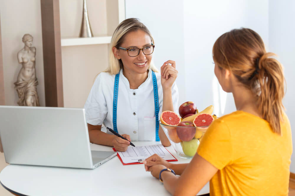 Nutritionist guiding patient on balanced eating habits for bulimia recovery