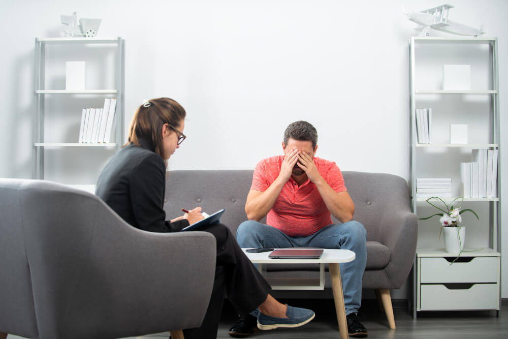 Man consulting a mental health professional for mood disorder symptoms