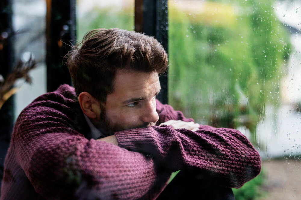 Man sitting alone feeling low, fatigued, and emotionally withdrawn in bipolar disorder