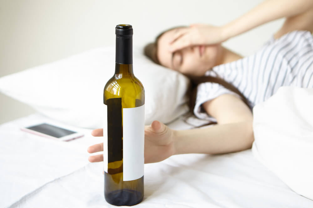 Young adult showing signs of alcohol abuse such as stress, risky behavior, and emotional distress while drinking.