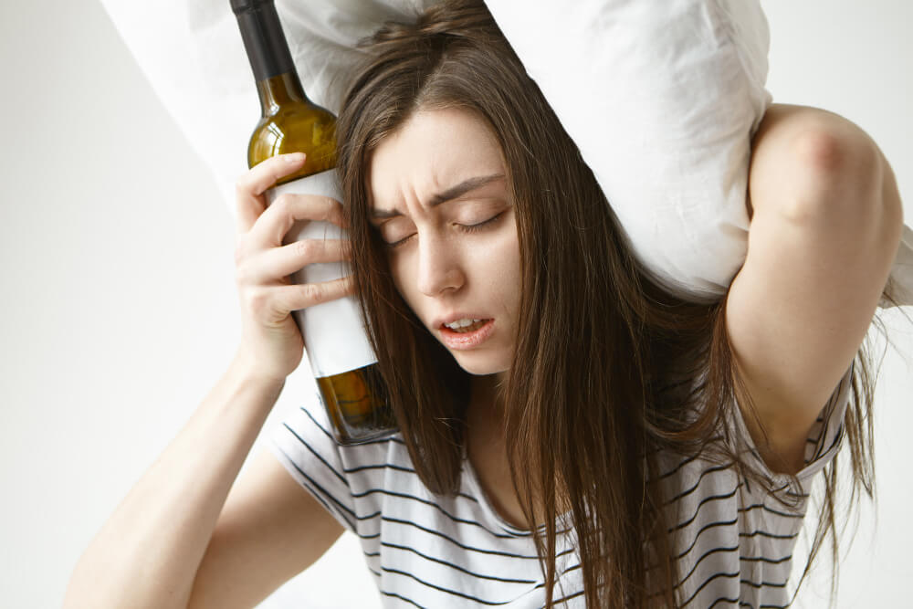 Person struggling with alcohol dependence showing compulsive drinking behavior and loss of control.