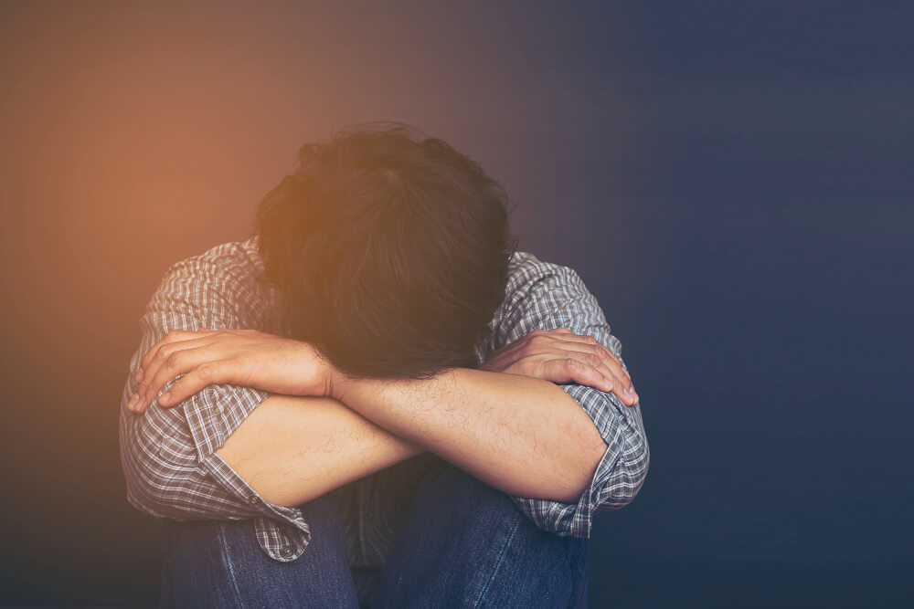 Person experiencing mood swings, irritability, and emotional instability