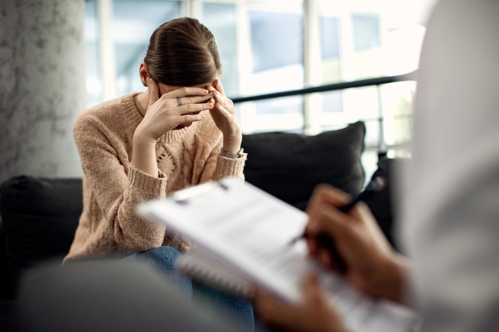 Doctor encouraging a recovering anorexia nervosa patient during a supportive mental health consultation.