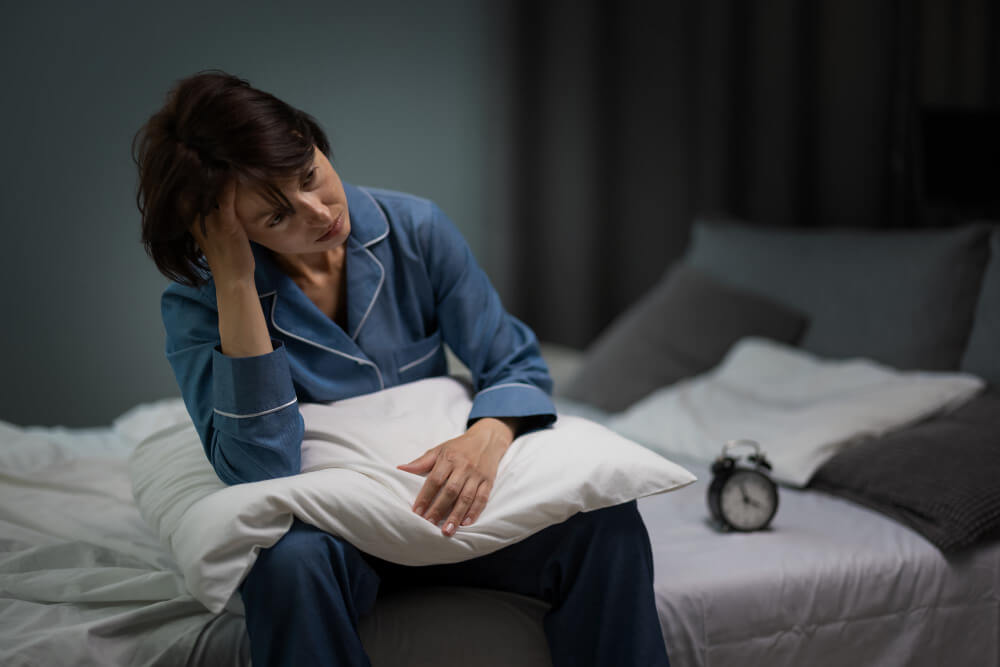 Woman waking up during the night because of insomnia